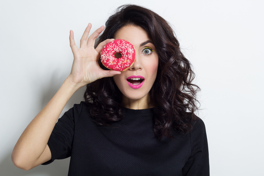 Portrait of beautiful woman with donut